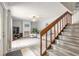 Inviting living room featuring a cozy fireplace and a staircase to the upper level at 3808 Saxon Dr, New Smyrna Beach, FL 32169