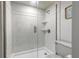 Bright shower with glass door, tiled walls, and toiletry shelves at 3808 Saxon Dr, New Smyrna Beach, FL 32169