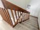 Staircase featuring wood railing and wood-look steps in a residential house at 3808 Saxon Dr, New Smyrna Beach, FL 32169