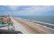 Beach view of ocean waves and shoreline with a blue sky and light clouds above from a high vantage point at 3855 S Atlantic Ave # 1503, Daytona Beach Shores, FL 32118
