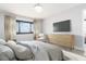 Bedroom showcasing a large window, television, dresser, and comfortable chair at 3855 S Atlantic Ave # 1503, Daytona Beach Shores, FL 32118