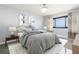 Bright bedroom featuring a large window with ocean view and stylish neutral decor at 3855 S Atlantic Ave # 1503, Daytona Beach Shores, FL 32118