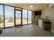 View of the pool from the fitness room; includes fitness signage and cleaning supplies at 3855 S Atlantic Ave # 1503, Daytona Beach Shores, FL 32118