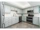 Kitchen featuring stainless steel appliances, custom cabinets, backsplash, and tiled floors at 3855 S Atlantic Ave # 1503, Daytona Beach Shores, FL 32118
