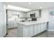 Kitchen with modern cabinets, stainless steel appliances, countertop seating, and backsplash at 3855 S Atlantic Ave # 1503, Daytona Beach Shores, FL 32118