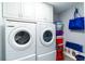 Laundry room with washer, dryer, and overhead cabinets at 3855 S Atlantic Ave # 1503, Daytona Beach Shores, FL 32118