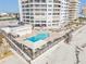 Aerial view of beachfront pool and lounge area at condo building at 3855 S Atlantic Ave # 1503, Daytona Beach Shores, FL 32118