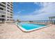 Outdoor pool deck featuring an ocean view and poolside seating at 3855 S Atlantic Ave # 1503, Daytona Beach Shores, FL 32118