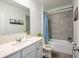 Bathroom featuring gray tile in the bath/shower and white cabinets at 3963 Willowbrook Dr, Edgewater, FL 32141