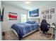 Bright bedroom with sports themed decor, including striped bedding and a stylish desk area at 3963 Willowbrook Dr, Edgewater, FL 32141
