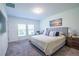 Well-lit bedroom featuring neutral colors, soft carpet, and a light-filled window at 3963 Willowbrook Dr, Edgewater, FL 32141