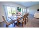 Bright dining area with a wooden table, seating for six, and a sliding glass door to the outdoors at 3963 Willowbrook Dr, Edgewater, FL 32141