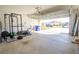 View of the open garage featuring ample space for parking and storage, plus workout equipment at 3963 Willowbrook Dr, Edgewater, FL 32141