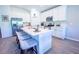 Bright, all-white kitchen features a center island with seating, stainless steel appliances, and modern finishes at 3963 Willowbrook Dr, Edgewater, FL 32141