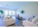 Bright living room featuring neutral furniture, large windows, and hardwood floors at 3963 Willowbrook Dr, Edgewater, FL 32141