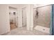 A spacious shower with tile surround, multiple shelves, and bench at 3963 Willowbrook Dr, Edgewater, FL 32141