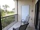 Private balcony with chairs, offering a serene outdoor retreat with views of the lush green landscape at 402 Bouchelle Dr # 205, New Smyrna Beach, FL 32169