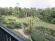 Scenic balcony view of lush landscaping and tropical trees offers a serene outdoor space at 402 Bouchelle Dr # 205, New Smyrna Beach, FL 32169