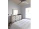 Bright bedroom with ceiling fan and white furnishings provides a peaceful retreat at 402 Bouchelle Dr # 205, New Smyrna Beach, FL 32169
