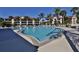 Expansive community pool with multiple entry points and tropical palm trees providing shade and a resort-like ambiance at 402 Bouchelle Dr # 205, New Smyrna Beach, FL 32169