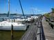 Scenic view of the community boat dock and walkway with multiple boats harbored at 402 Bouchelle Dr # 205, New Smyrna Beach, FL 32169