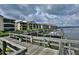 Waterfront view of a residential complex with a private dock, offering convenient boat access and stunning water views at 402 Bouchelle Dr # 205, New Smyrna Beach, FL 32169