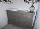 Walk in closet featuring a gray dresser with seven drawers and a lamp at 402 Bouchelle Dr # 205, New Smyrna Beach, FL 32169