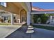 Inviting entrance to Bouchelle Island featuring a covered drop-off, lush landscaping, and beautiful double doors at 402 Bouchelle Dr # 205, New Smyrna Beach, FL 32169