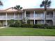 Attractive two-story condo with well-manicured lawn and palm trees offers curb appeal at 402 Bouchelle Dr # 205, New Smyrna Beach, FL 32169