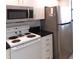 Efficient kitchen features white appliances, drawers, and black counters at 402 Bouchelle Dr # 205, New Smyrna Beach, FL 32169