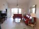 Inviting living room with tile floors, comfortable seating, and sliding glass doors leading to the balcony at 402 Bouchelle Dr # 205, New Smyrna Beach, FL 32169