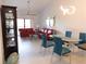 Bright living room featuring a vaulted ceiling, modern lighting, and an adjacent dining area for seamless entertaining at 402 Bouchelle Dr # 205, New Smyrna Beach, FL 32169