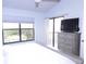 Bright main bedroom with white carpet, a ceiling fan, and a large window at 402 Bouchelle Dr # 205, New Smyrna Beach, FL 32169