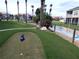 Well-maintained putting green area with lush landscaping in a beautiful community setting at 402 Bouchelle Dr # 205, New Smyrna Beach, FL 32169