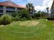Putting green with lush landscaping in the community at 402 Bouchelle Dr # 205, New Smyrna Beach, FL 32169