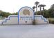 Bouchelle Island sign, trimmed in blue, welcomes residents and guests to this waterfront community at 402 Bouchelle Dr # 205, New Smyrna Beach, FL 32169