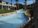 Scenic view of the community's lazy river water feature with lush landscaping at 402 Bouchelle Dr # 205, New Smyrna Beach, FL 32169