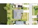 Drone shot of a home's backyard, waterfront view, landscaping, and proximity to nearby homes and neighborhood streets at 404 Central Mariners Dr, Edgewater, FL 32141
