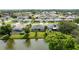 An aerial view of a well-manicured backyard with a lake view and outdoor seating at 404 Central Mariners Dr, Edgewater, FL 32141