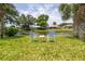 Inviting backyard view showcasing seating area by the water, perfect for relaxation and outdoor enjoyment at 404 Central Mariners Dr, Edgewater, FL 32141