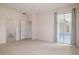Spacious bedroom with tile floors, neutral paint, and access to bathroom and outdoor patio at 404 Central Mariners Dr, Edgewater, FL 32141