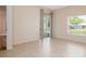 Bedroom featuring tile floors, neutral paint, sliding glass door with backyard views at 404 Central Mariners Dr, Edgewater, FL 32141