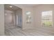 A bright entryway featuring wood-look floors, arched doorway, and a view from the front door at 404 Central Mariners Dr, Edgewater, FL 32141