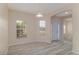 Bright entryway with wood-look floors, white trim, and arched doorway to other rooms at 404 Central Mariners Dr, Edgewater, FL 32141