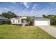 Charming single-story home featuring a well-maintained lawn and attached two-car garage at 404 Central Mariners Dr, Edgewater, FL 32141