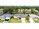 Beautiful single-story home overlooking the water, manicured lawn, two-car garage, and tropical landscaping at 404 Central Mariners Dr, Edgewater, FL 32141