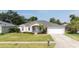 Charming single-story home boasting a well-kept lawn, landscaped garden, and an attached two-car garage at 404 Central Mariners Dr, Edgewater, FL 32141