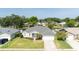 Beautiful single-story home featuring a manicured lawn, two-car garage, and tropical landscaping at 404 Central Mariners Dr, Edgewater, FL 32141