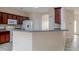 Eat-in kitchen featuring granite counters, wood cabinets, and modern appliances at 404 Central Mariners Dr, Edgewater, FL 32141