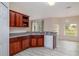 Kitchen featuring stainless steel sink, updated appliances, granite counters, and wood cabinets at 404 Central Mariners Dr, Edgewater, FL 32141
